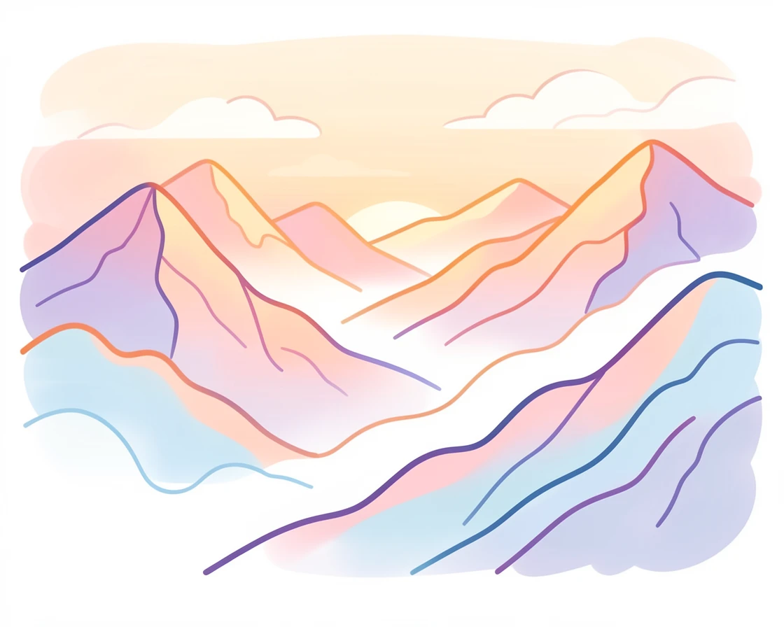 A mist-covered mountain range at sunrise with layered ridgelines fading into the distance.