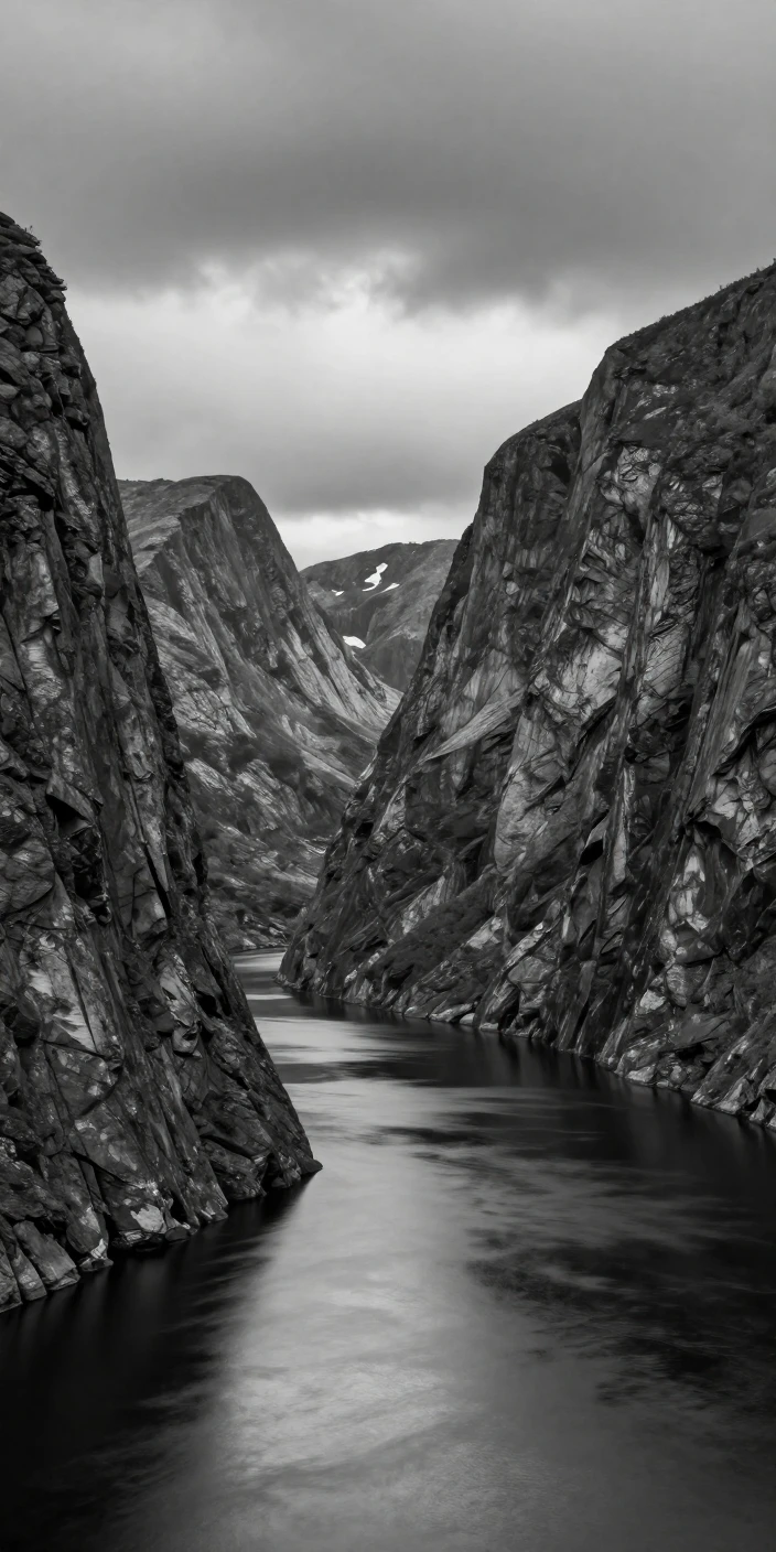 A fjord cuts deep between towering cliffs along the Norwegian coast.
