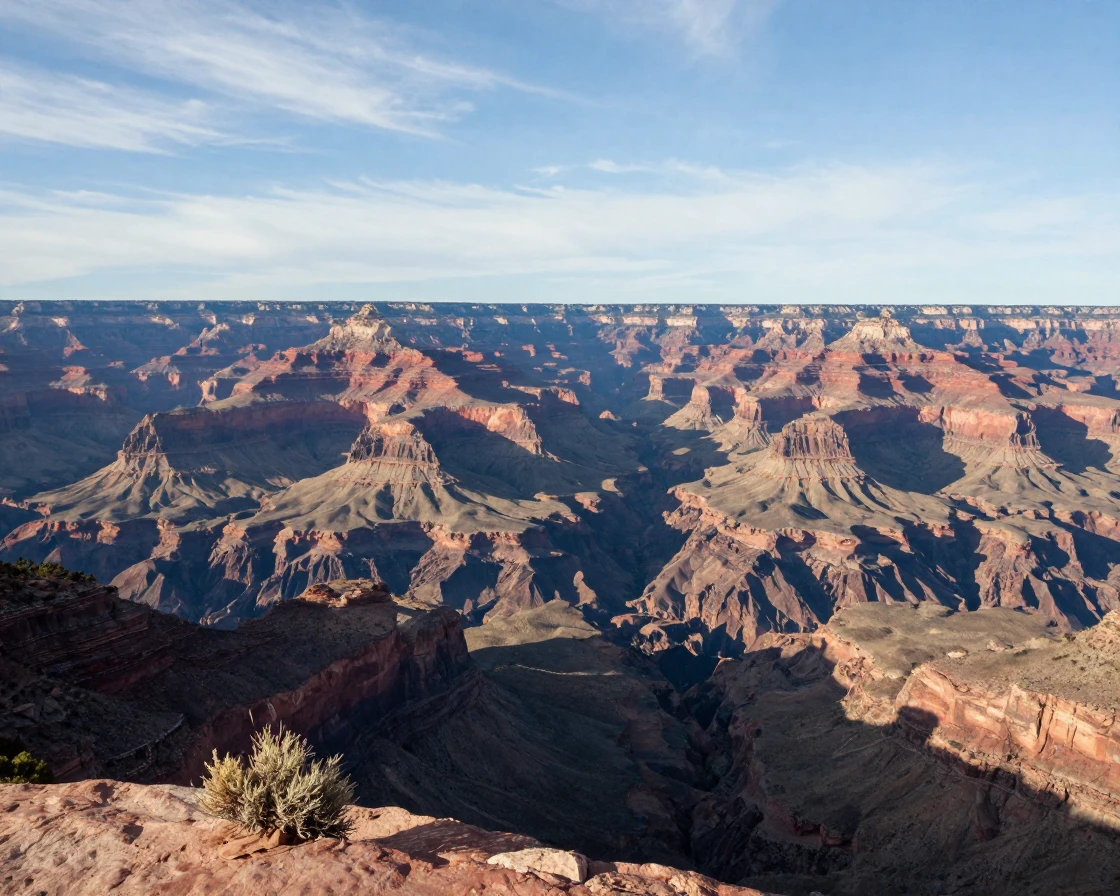 A canyon overlook reveals miles of layered rock stretching to the horizon.